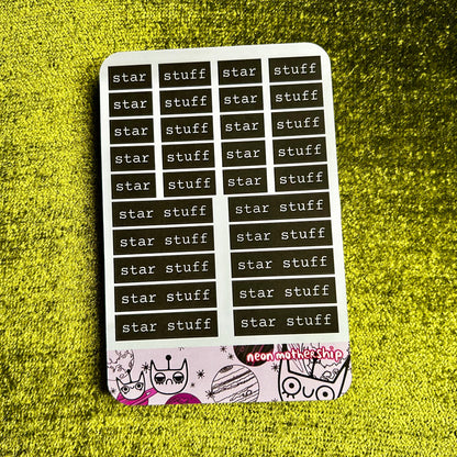 Sticker sheet with 'star stuff' text on a green textured surface