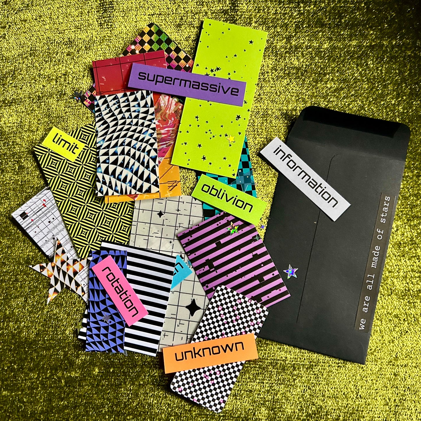 Collection of colorful papers with text on a textured green surface