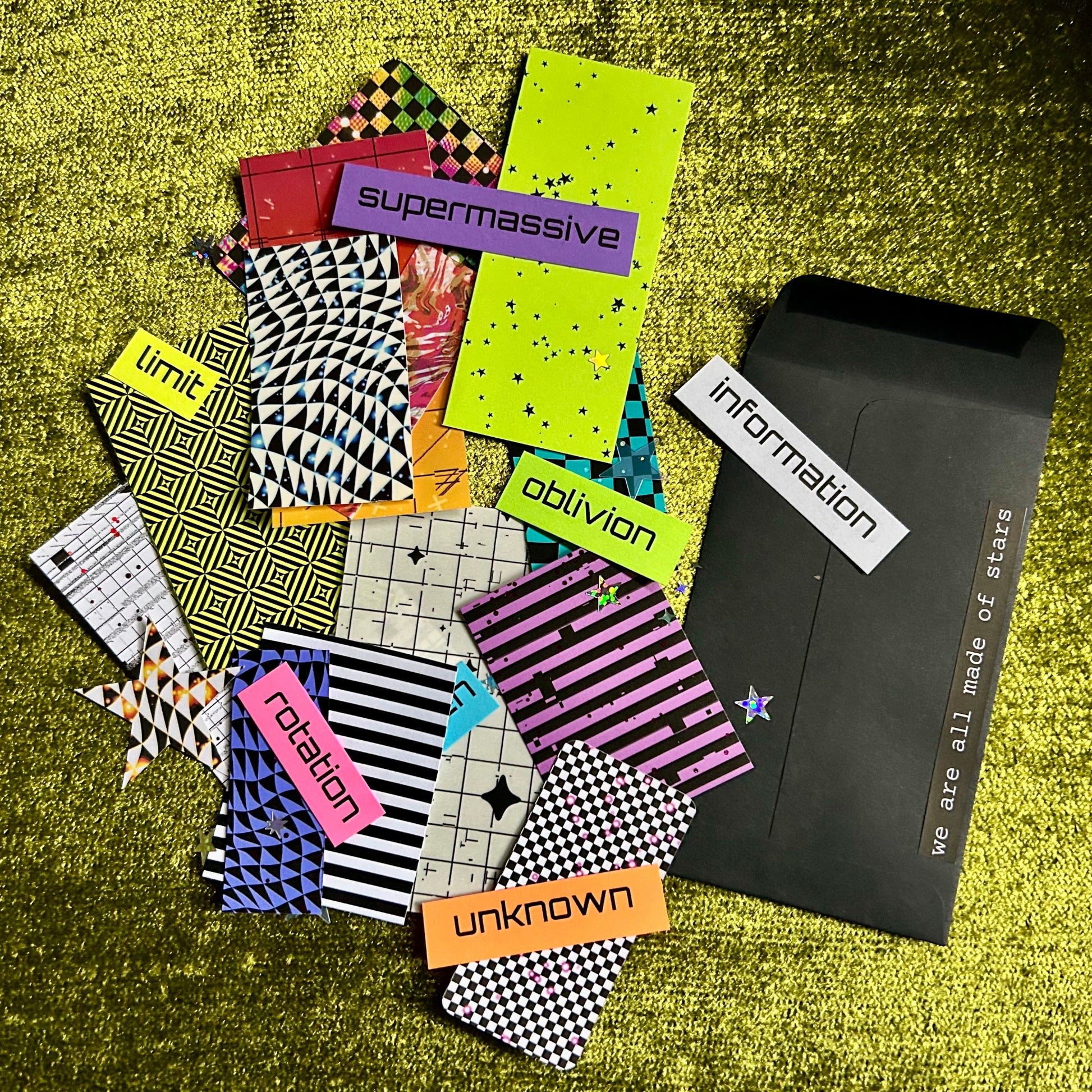 Collection of colorful papers with text on a textured green surface