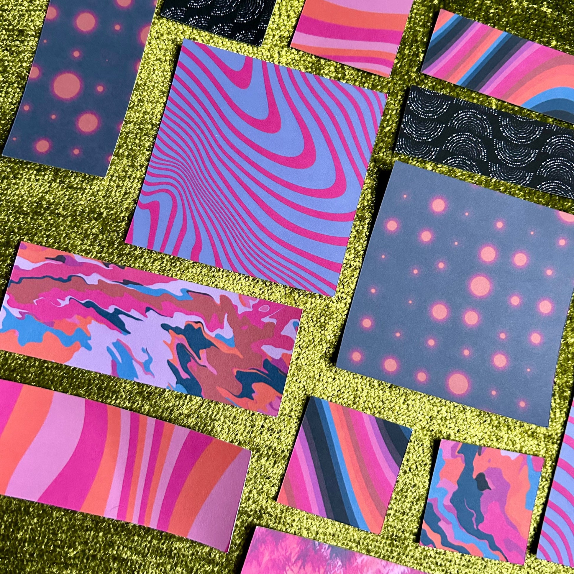 Collage of various pink and purple sticker scraps on a green textured background