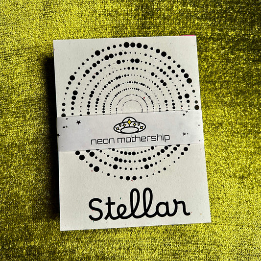 paper with 'neon mothership Stellar' text on a textured green background