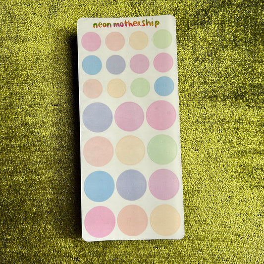 Sheet of pastel-colored round stickers with 'neon mothership' branding on a green textured background.