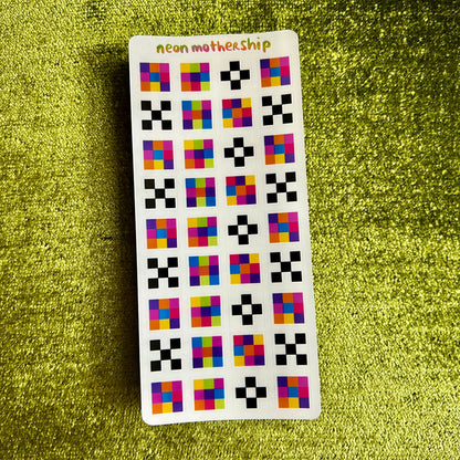 Sticker sheet with colorful geometric square stickers on a green textured background