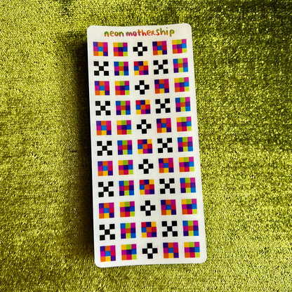 Card with colorful square pattern on a green textured surface