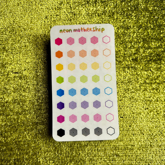 sticker sheet with hexagonal patterns on a green textured background