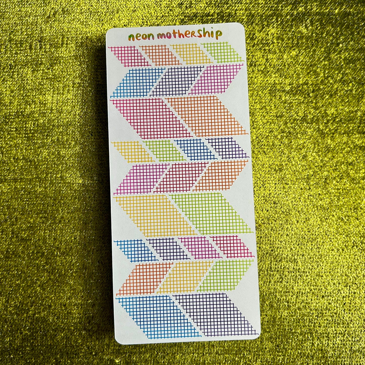 sticker sheet with geometric patterns on a green textured surface