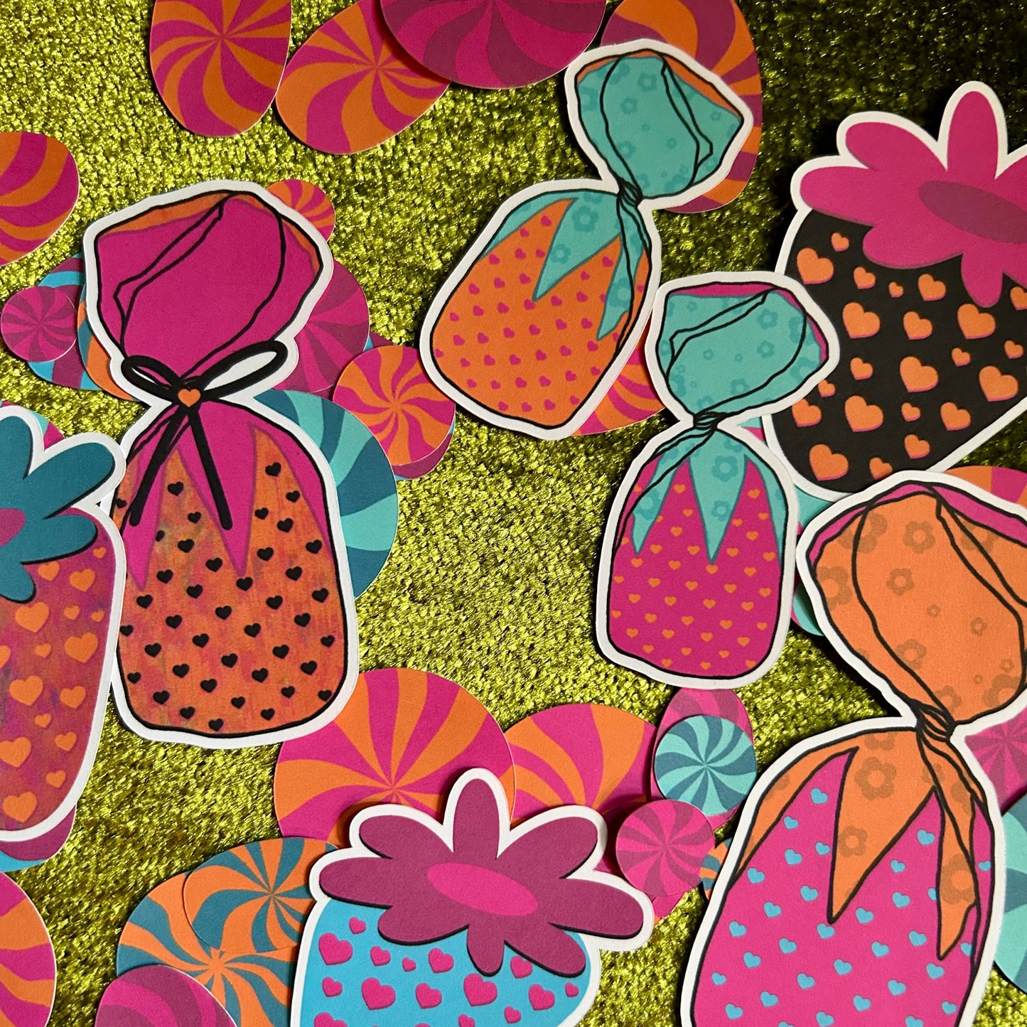 Colorful candy-themed stickers on a textured green background
