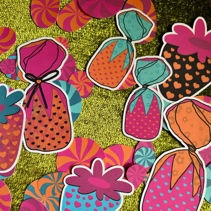 Colorful candy-themed stickers on a textured green background