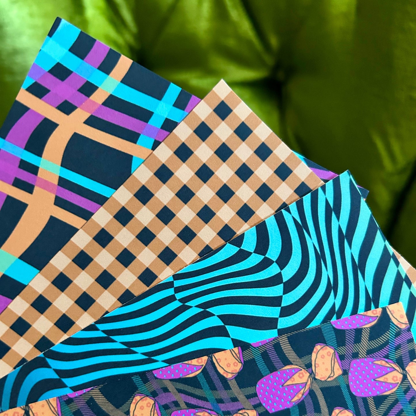 Four sticker sheets with different patterns on a green background