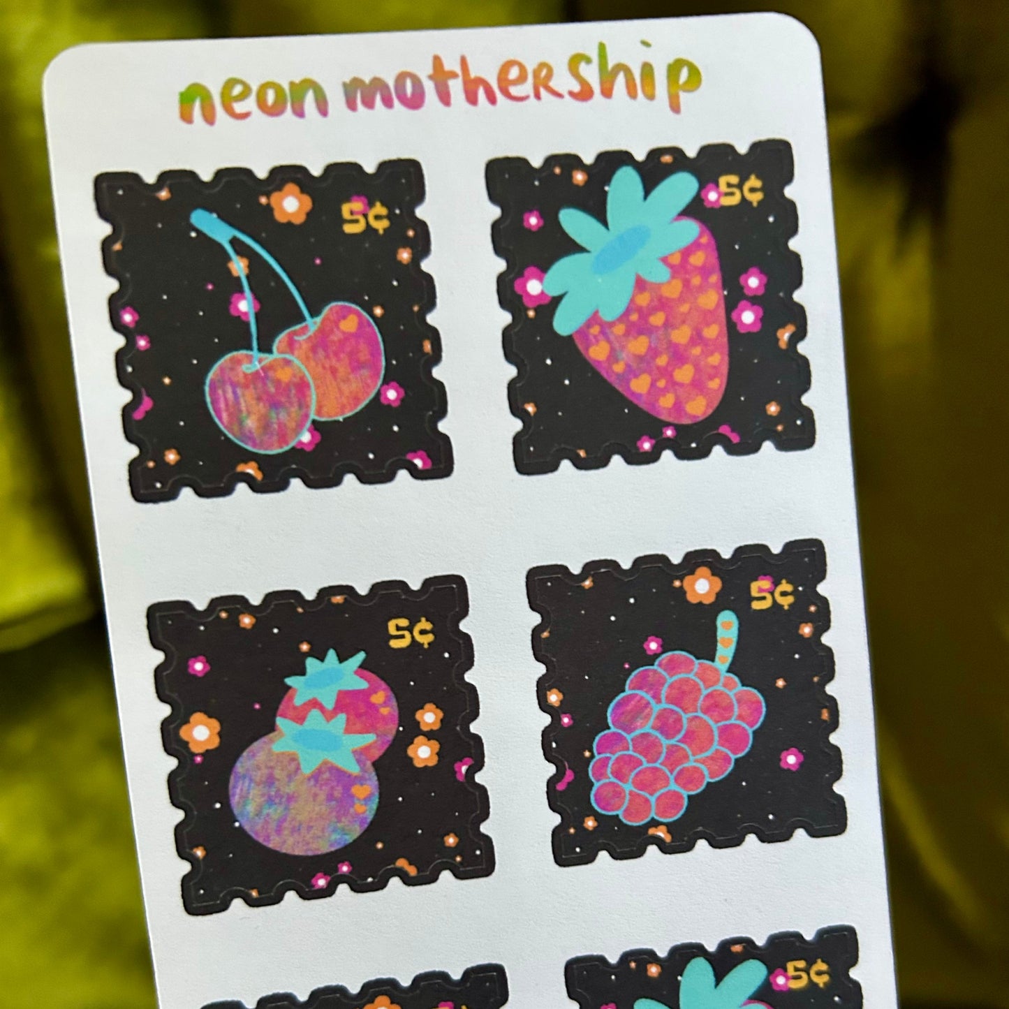 Sheet of colorful fruit-themed stickers with 'neon mothership' branding on a white background.