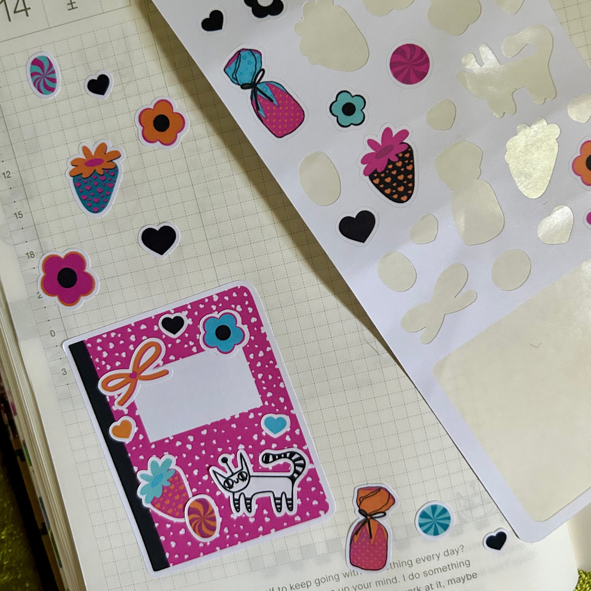 Sheet of colorful stickers with decorative designs on a notebook page.