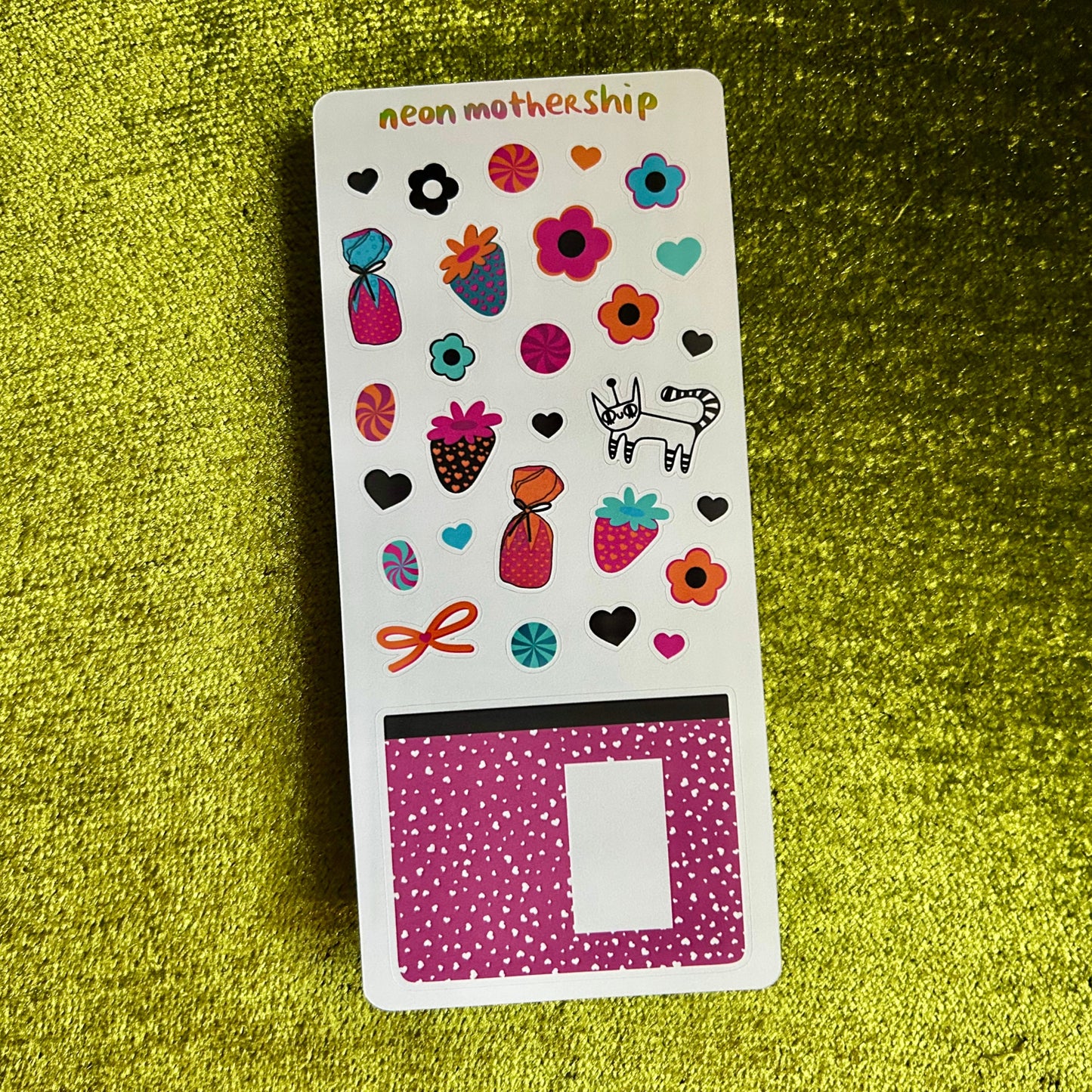 Sticker sheet with colorful designs on a green textured background