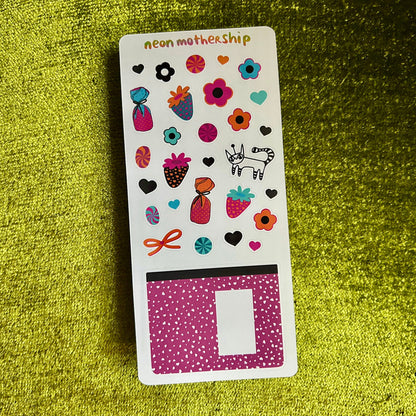 Sticker sheet with colorful designs on a green textured background