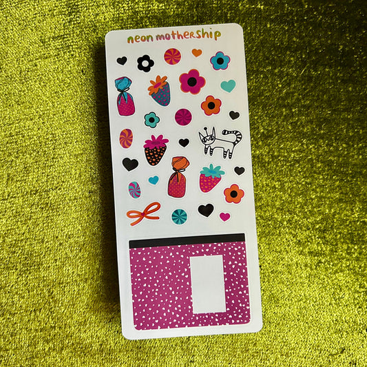 Sticker sheet with colorful designs on a green textured background