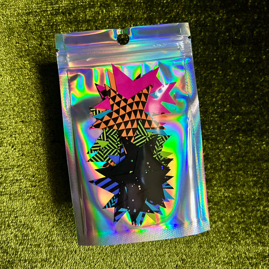 Holographic pouch with geometric design on a green textured surface