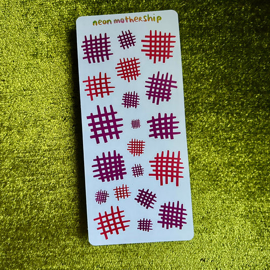 Card with red and purple patterns on a green textured surface