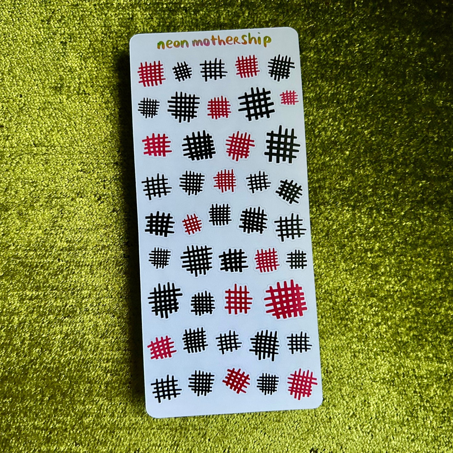 sticker sheet with a pattern on a green textured surface