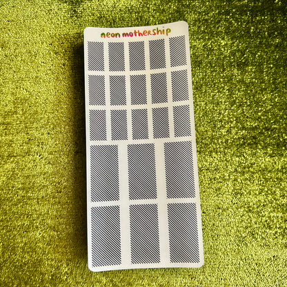 Small rectangular sticker sheet with 'neon motherShip' branding on a green textured surface