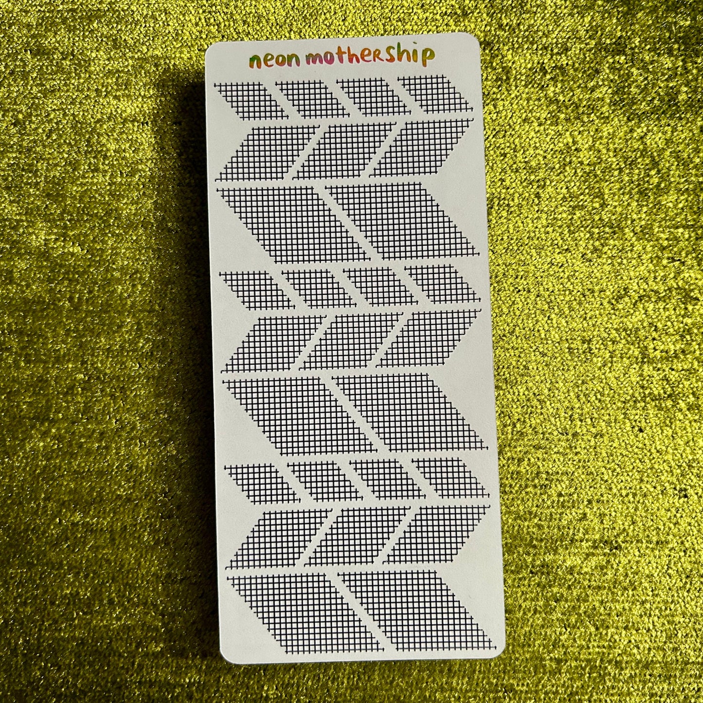 sticker sheet with geometric pattern on a green textured background