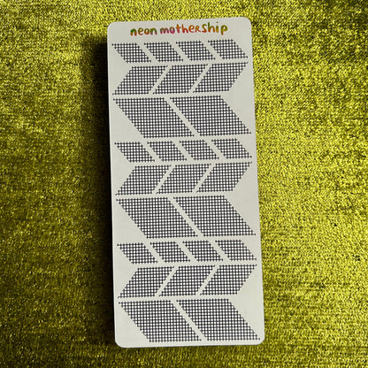 sticker sheet with geometric pattern on a green textured background