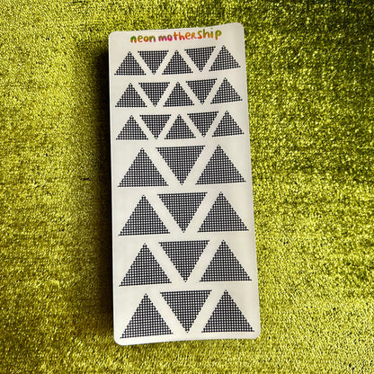 sticker sheet with geometric pattern on a green textured surface