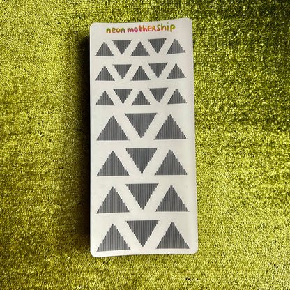 Rectangular sticker sheet with geometric triangle pattern on a green textured background