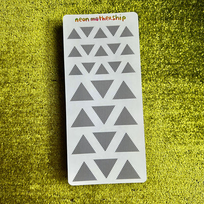 sticker sheet with geometric pattern on a green textured surface