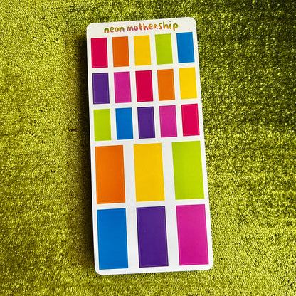 sticker sheet with neon colors on a green textured background