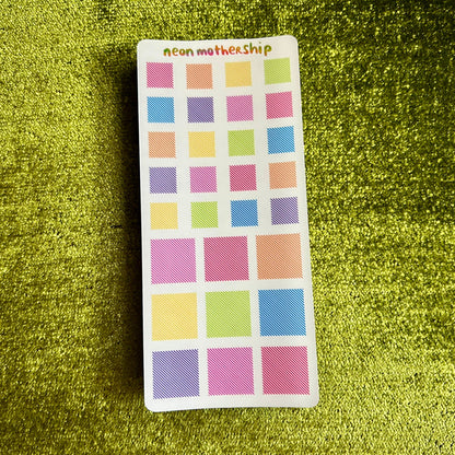 sticker sheets with square stickers on a green textured background