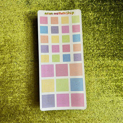 Pack of colorful spiral-patterned stickers on a green textured background