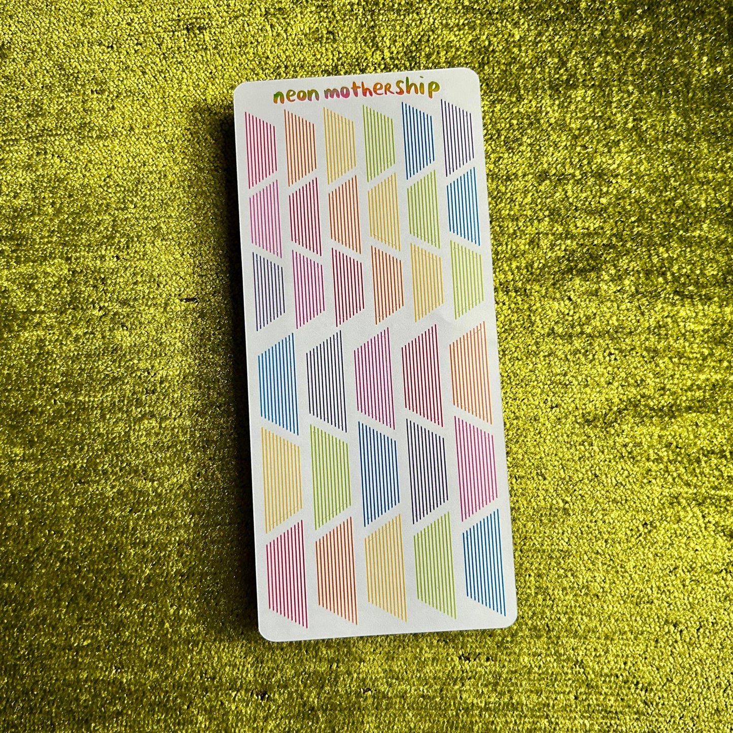 sticker sheet with geometric patterns on a green textured background