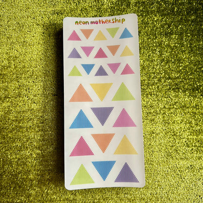 Sticker with colorful triangle pattern on a green textured background